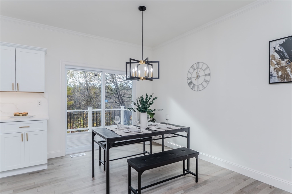 135 Thompson Street Palmer, MA 01069 - Photo 9 of 39 a view of a room with a table chairs and wooden floor