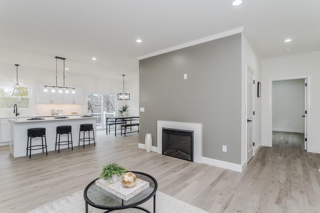 135 Thompson Street Palmer, MA 01069 - Photo 10 of 39 a living room with furniture a fireplace and kitchen view