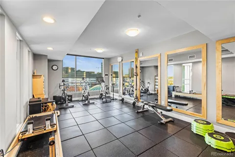 a room with gym equipment and large mirror