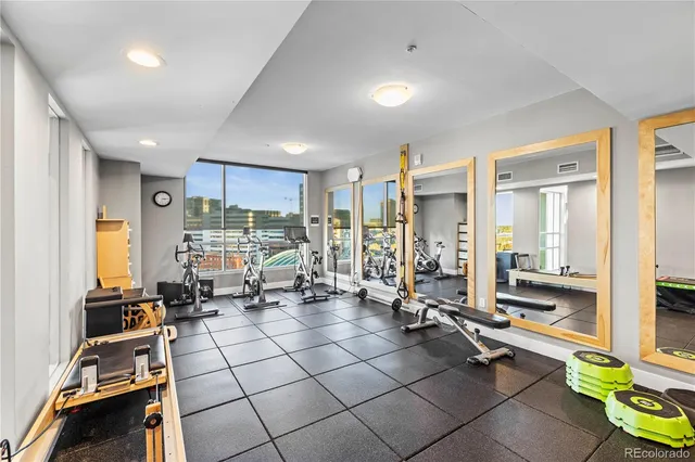 a room with gym equipment and large mirror