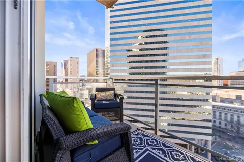 a view of a city with furniture and a back yard