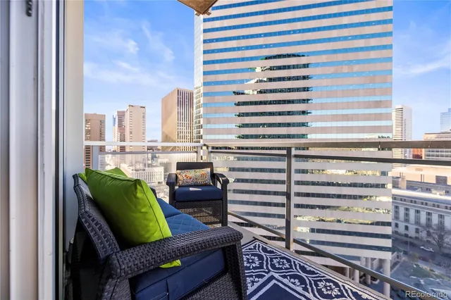 a view of a city with furniture and a back yard