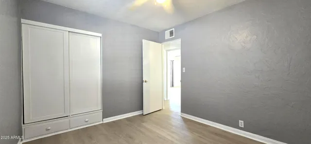 an empty room with wooden floor