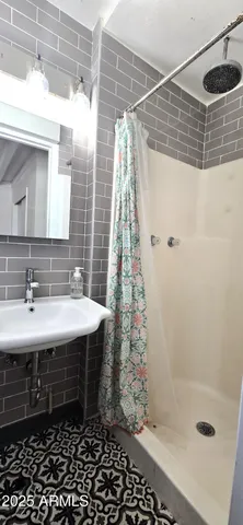 a bathroom with a sink and shower