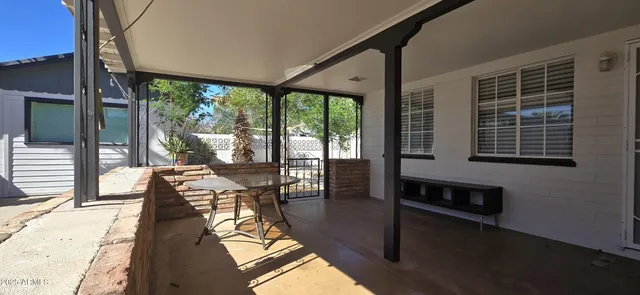 a living room with furniture and a floor to ceiling window