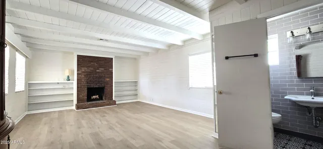 a view of an empty room and fire place