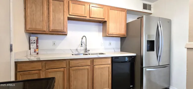 a kitchen with stainless steel appliances granite countertop a sink and cabinets
