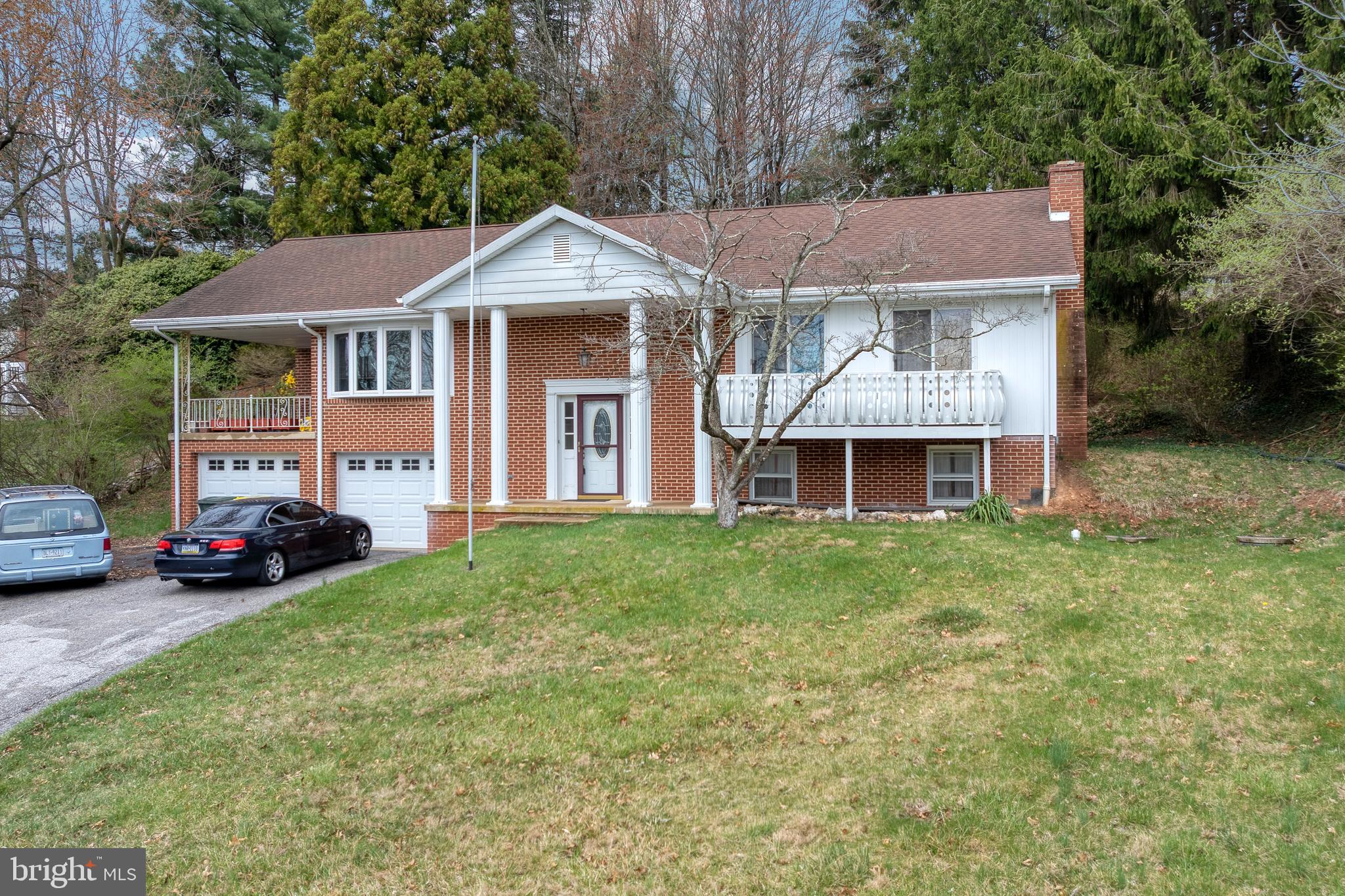 175 Scott Road York, PA 17403 - Photo 3 of 34 a front view of a house with a garden and deck