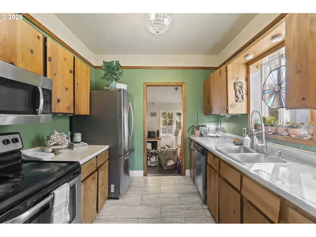 a kitchen with a sink appliances and cabinets