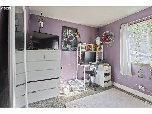 a living room with furniture a flat screen tv and floor to ceiling window