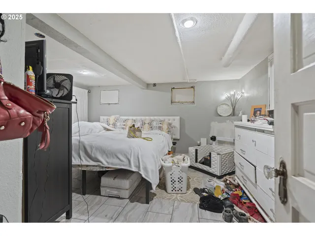 a bedroom with a bed window and a television