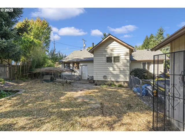 a backyard of a house with table and chairs
