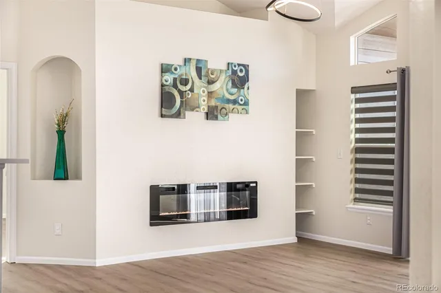 a view of a living room with wooden floor