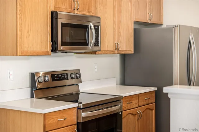 a kitchen with wooden cabinets and a stove top oven