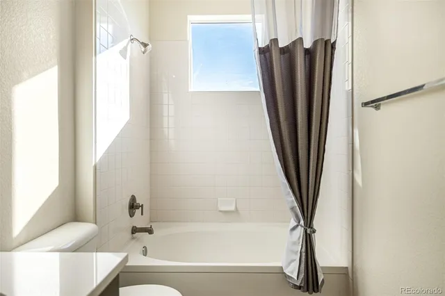 a bathroom with a bathtub and a window