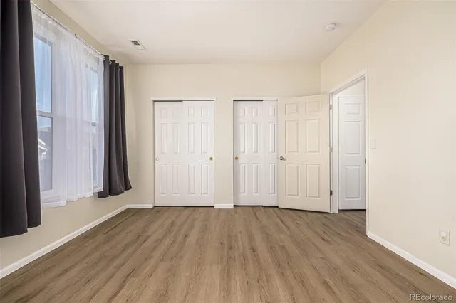 an empty room with wooden floor
