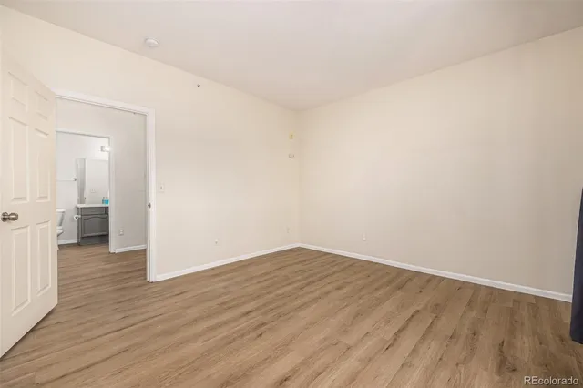 a view of a room with wooden floor