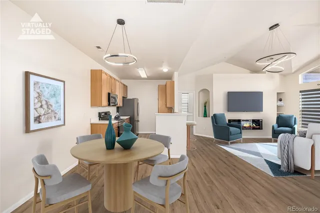 a view of a dining room with furniture wooden floor and a chandelier