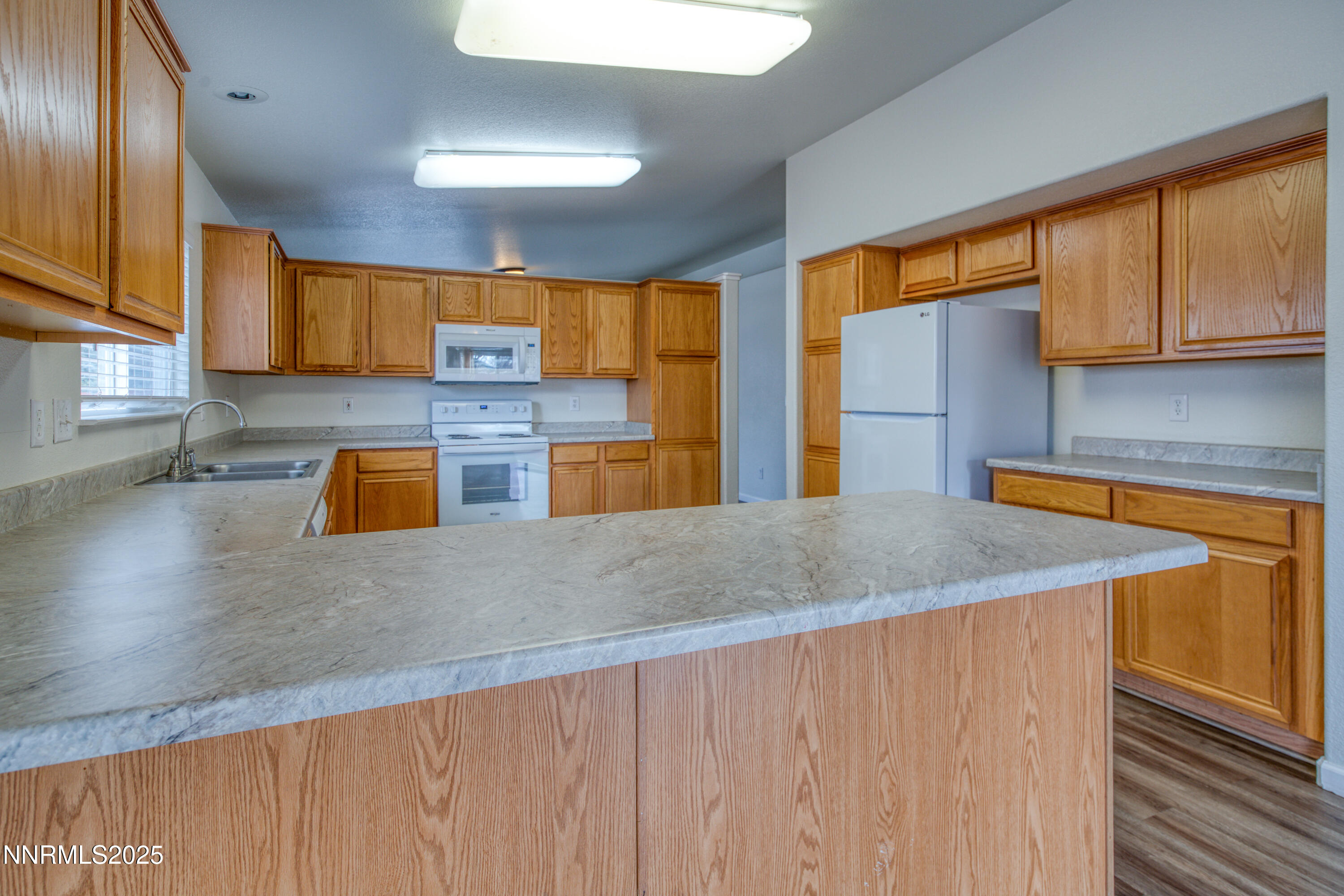 17780 Oakview Court Reno, NV 89508 - Photo 14 of 38 a kitchen with stainless steel appliances granite countertop a sink a stove counter space and a window