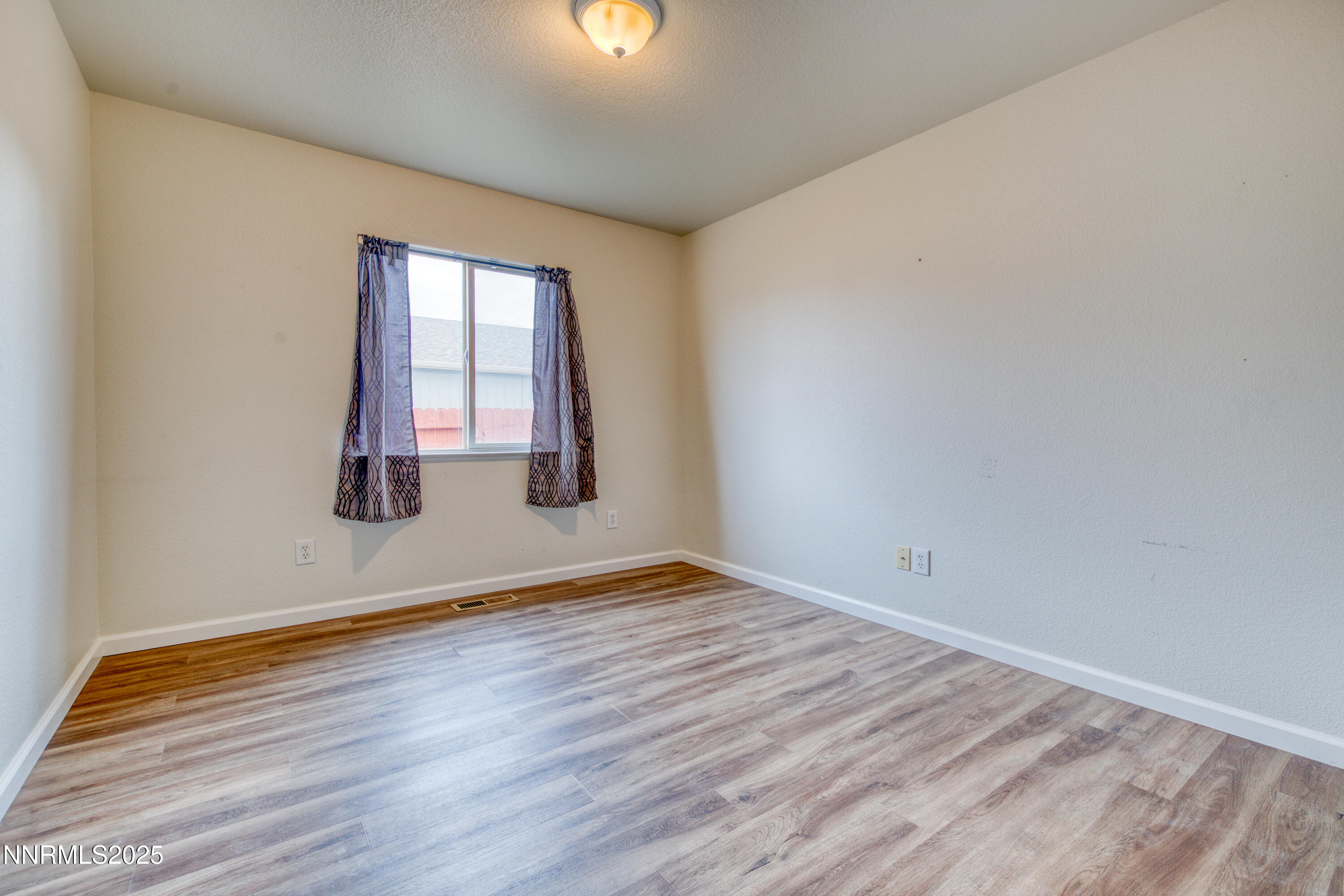 17780 Oakview Court Reno, NV 89508 - Photo 28 of 38 a view of an empty room with wooden floor and a window