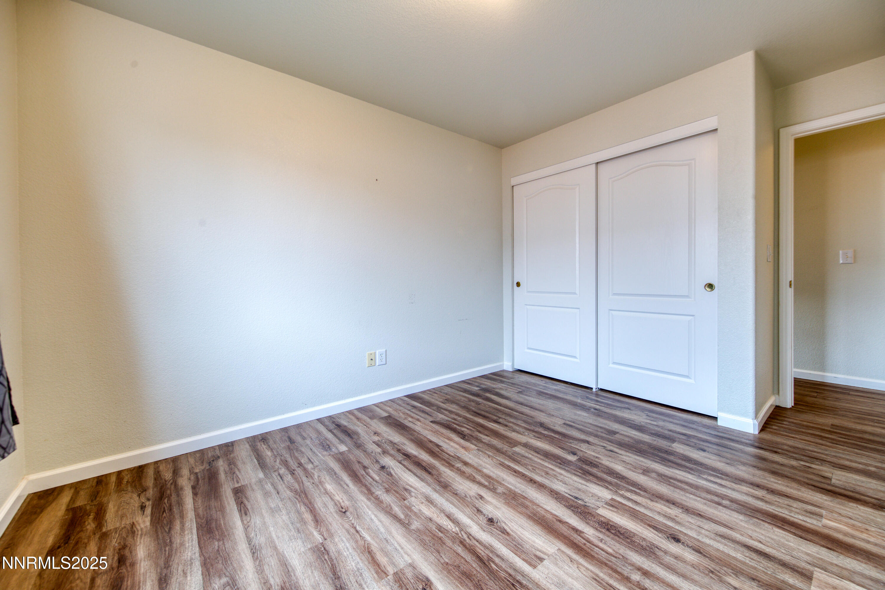 17780 Oakview Court Reno, NV 89508 - Photo 29 of 38 a view of an empty room with wooden floor and closet