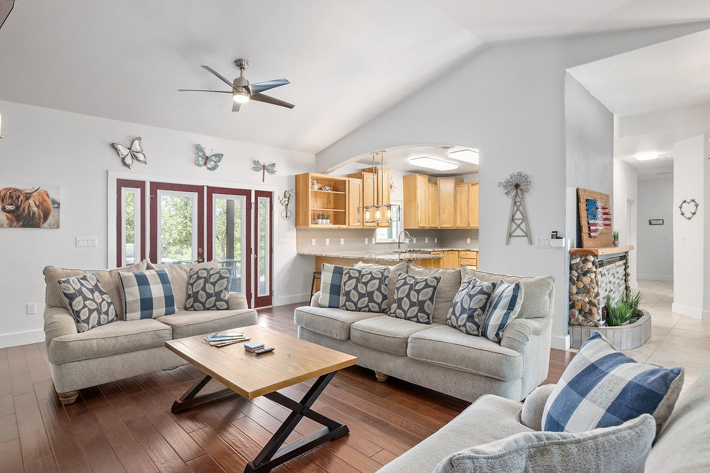 13326 Trautwein Road Austin, TX 78737 - Photo 5 of 38 Living room featuring a ceiling fan, high vaulted ceiling, baseboards, and wood finished floors