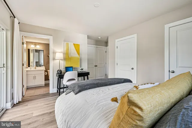 a bedroom with a bed and a couch