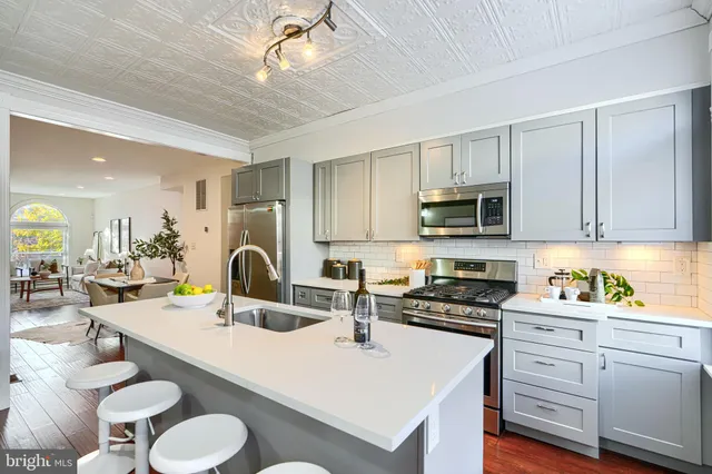 a kitchen with stainless steel appliances a refrigerator sink and stove