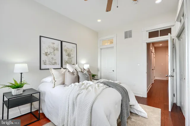 a bedroom with a large bed and a chandelier