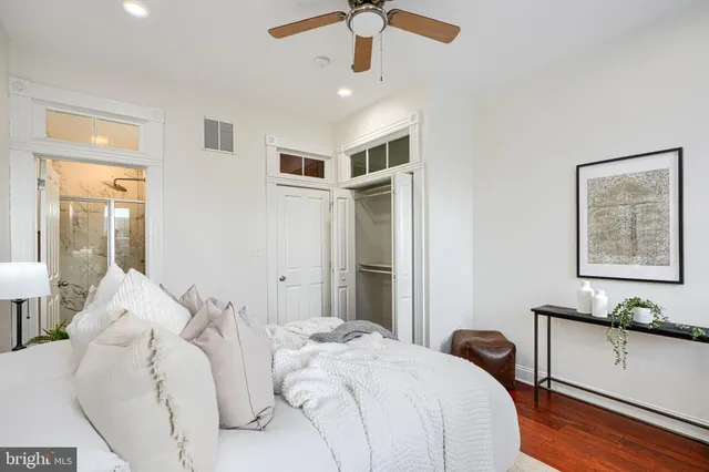 a bathroom with a granite countertop shower and a toilet