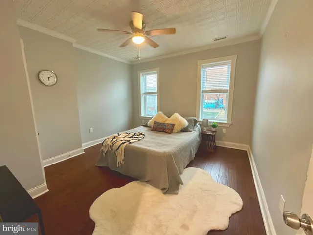 a view of wooden floor and a chandelier in a room