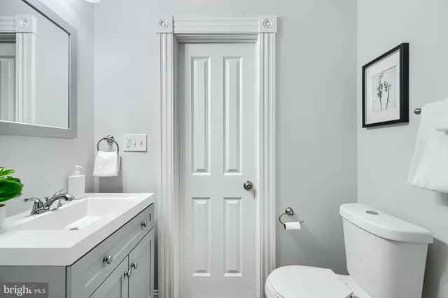 a bathroom with a white bath tub a sink and mirror