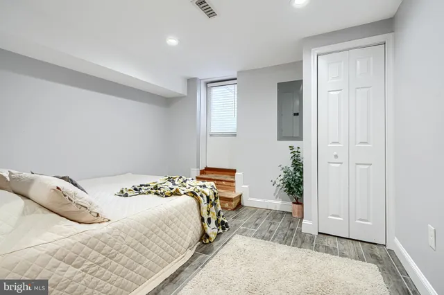 a bed room with a bed and a painting on the wall