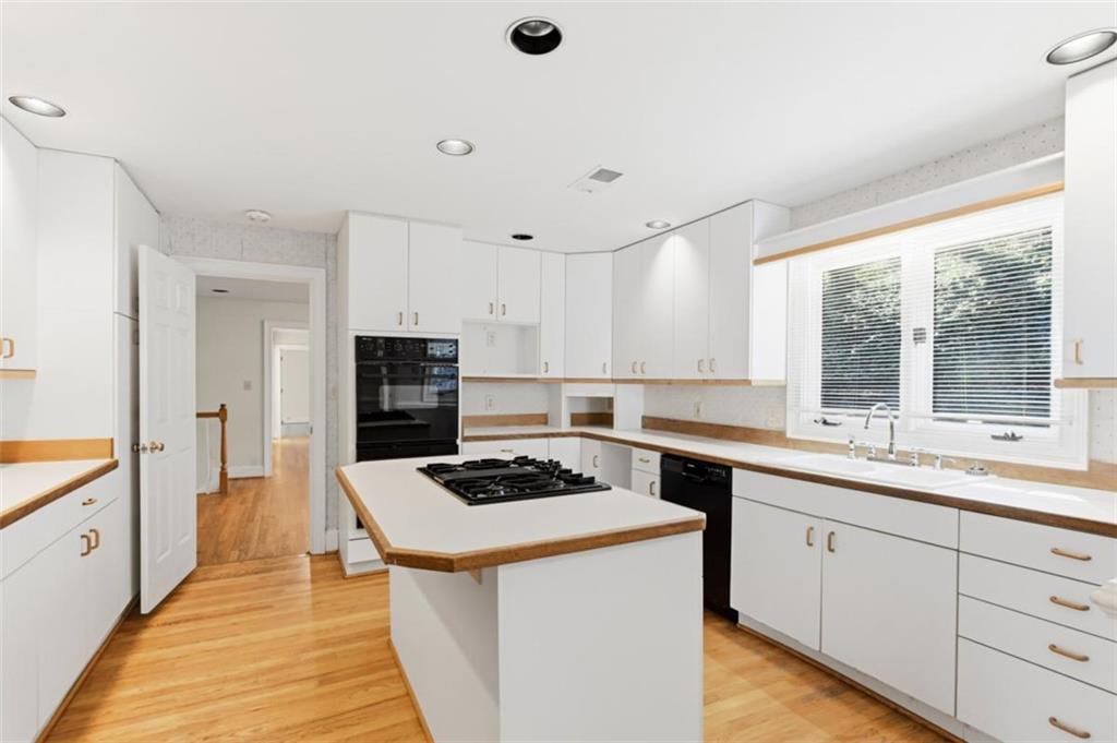 3959 Randall Mill Road Northwest Atlanta, GA 30327 - Photo 11 of 31 a kitchen with stainless steel appliances kitchen island a stove a sink and a refrigerator