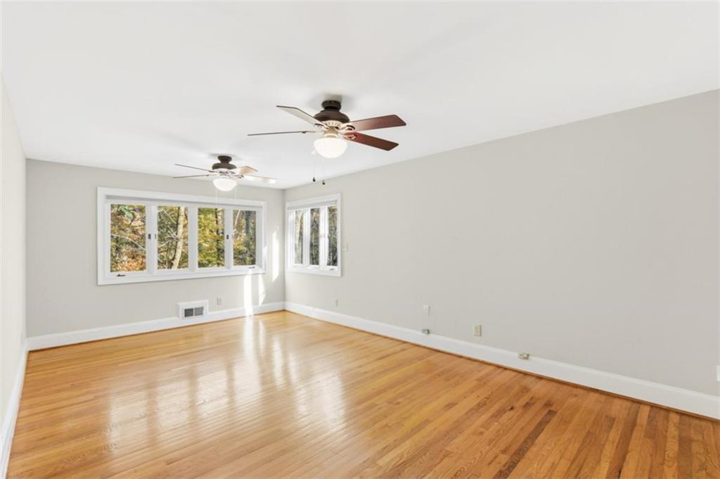 3959 Randall Mill Road Northwest Atlanta, GA 30327 - Photo 15 of 31 an empty room with wooden floor and windows
