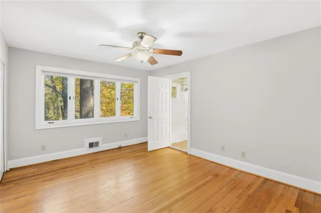wooden floor in an empty room with a window