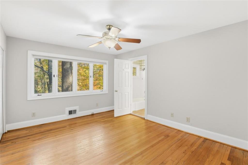 3959 Randall Mill Road Northwest Atlanta, GA 30327 - Photo 16 of 31 wooden floor in an empty room with a window