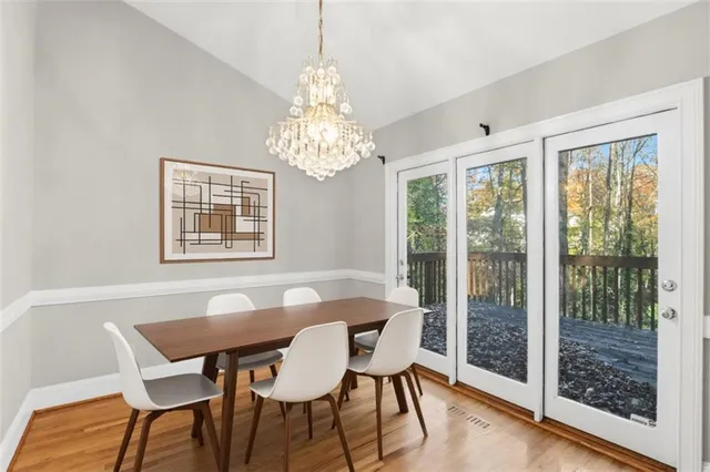 a view of a dining room with furniture wooden floor and chandelier