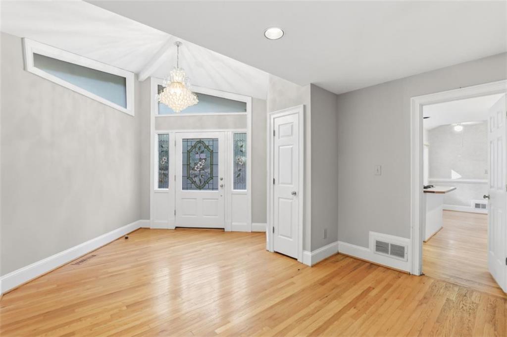 3959 Randall Mill Road Northwest Atlanta, GA 30327 - Photo 8 of 31 a view of an empty room with wooden floor and a window