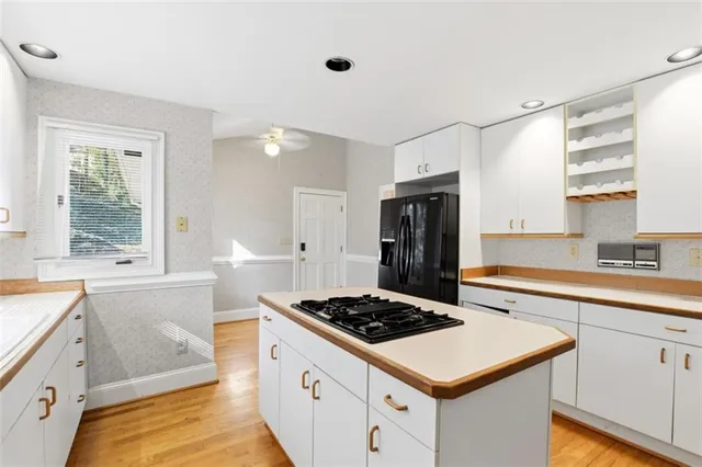 a kitchen with a stove a sink and a refrigerator