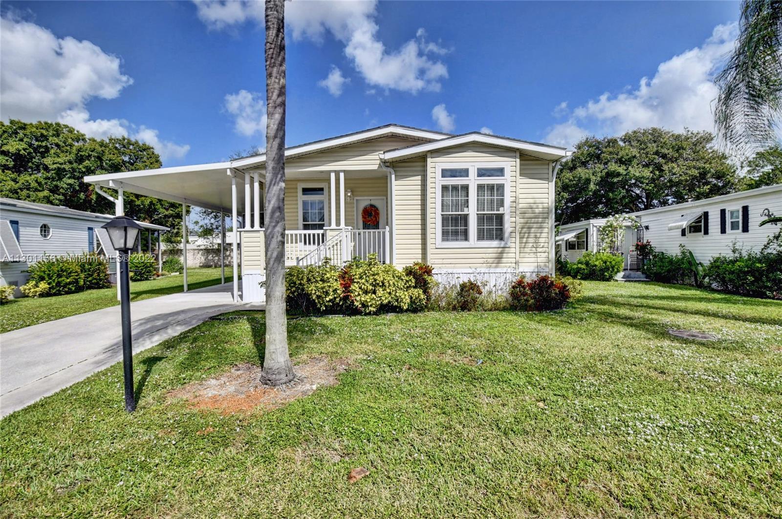 8293 East Club Road Boca Raton, FL 33433 - Photo 3 of 41 a view of a house with backyard and porch