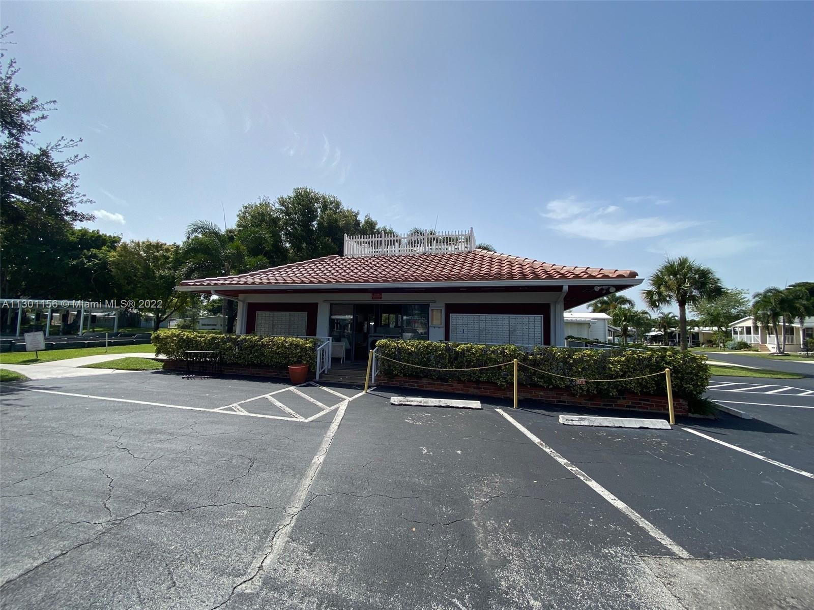 8293 East Club Road Boca Raton, FL 33433 - Photo 35 of 41 a view of a patio with table and chairs under an umbrella