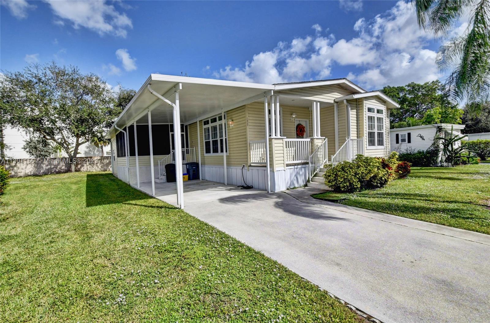 8293 East Club Road Boca Raton, FL 33433 - Photo 4 of 41 front view of a house with a yard