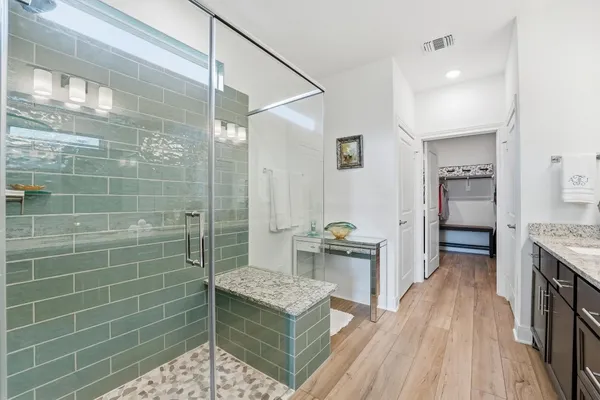 a view of walk in closet with clothes and shoes