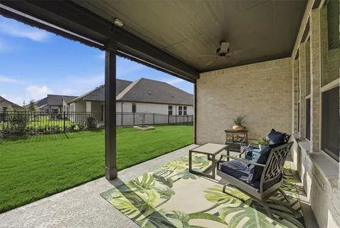 a view of a couches in patio with a yard