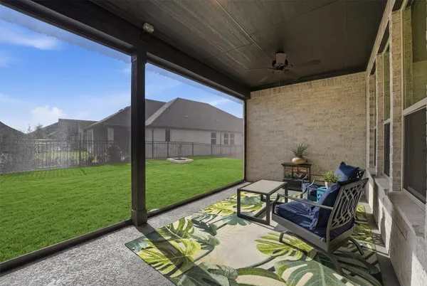 a balcony with furniture and a potted plant