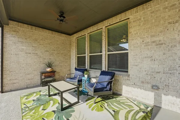 a view of a patio with table and chairs and a yard