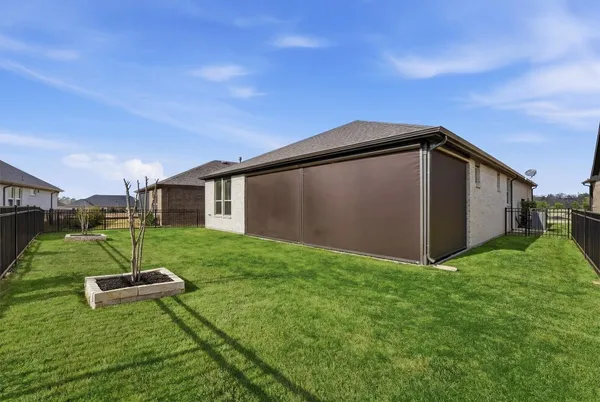 a view of a house with backyard porch and garden