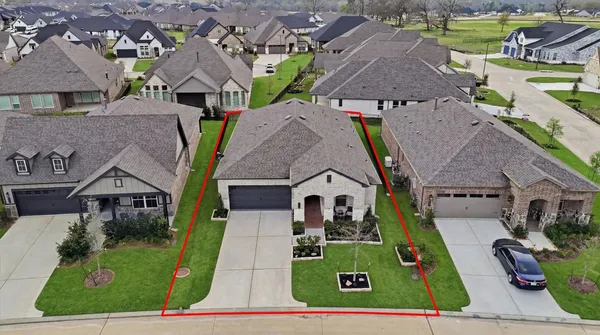 an aerial view of multiple houses with a yard