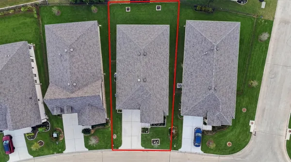 front view of a brick house with a yard